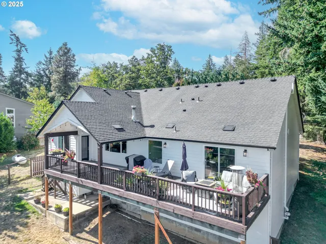 aerial view of house with deck and outdoor seating