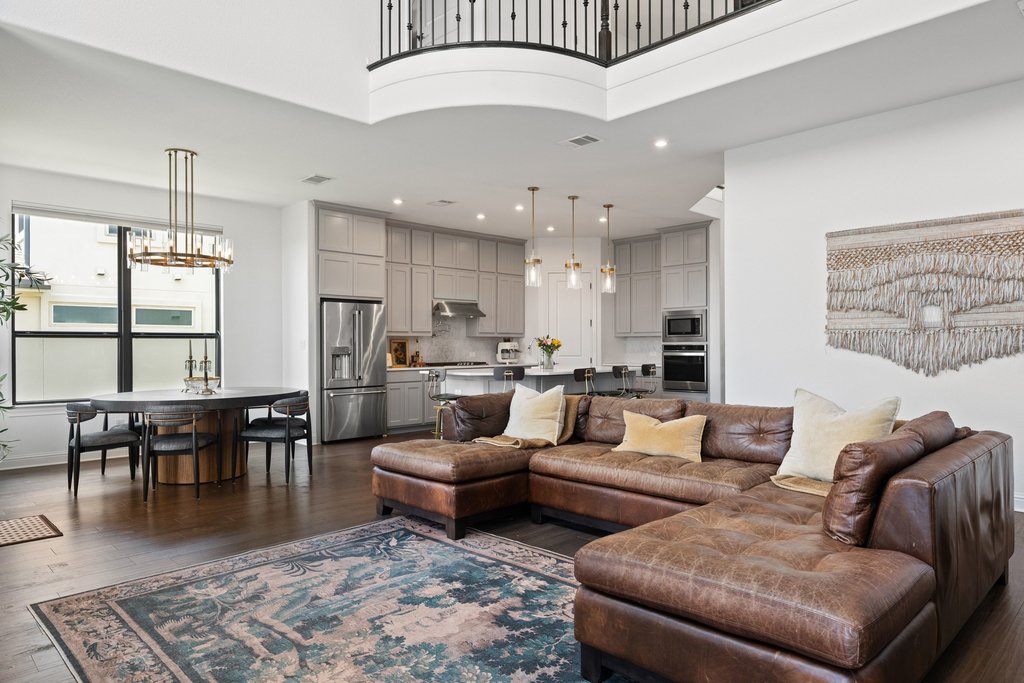 1221 Siena Sunset Road Leander, TX 78641 - Photo 13 of 39 Spacious open-concept living area featuring high ceilings and dark wood-finish flooring