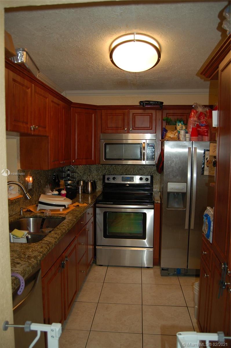 8600 Southwest 149th Avenue, Unit 612 Miami, FL 33193 - Photo 4 of 8 Stainless steel appliances with granite counter tops
