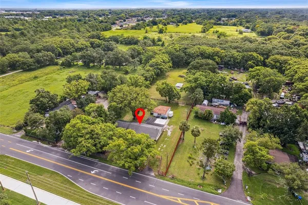 an aerial view of residential houses with outdoor space and swimming pool