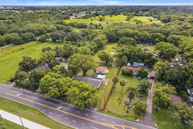 an aerial view of residential houses with outdoor space and river