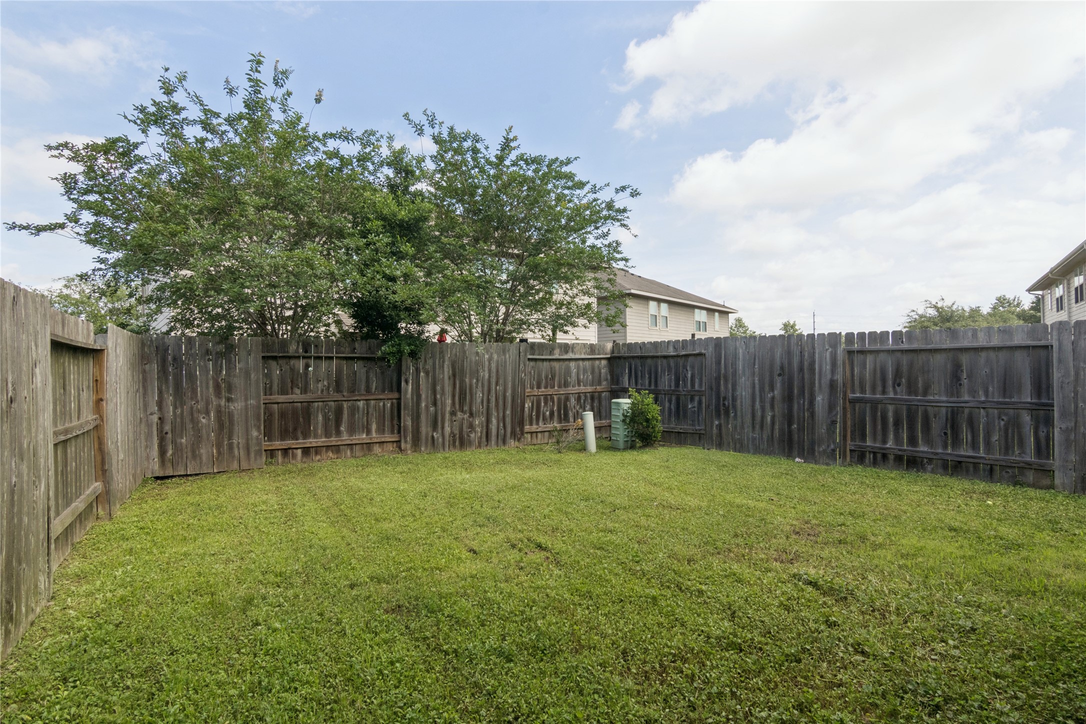 1815 Ryon Falls Drive Richmond, TX 77469 - Photo 23 of 24 a view of a yard with a fence and trees