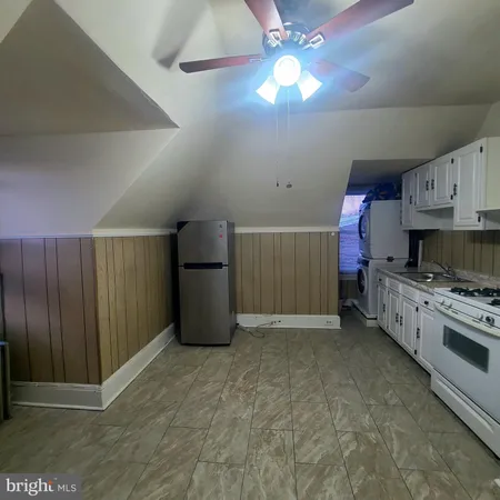 a view of a kitchen with cabinets and stainless steel appliances