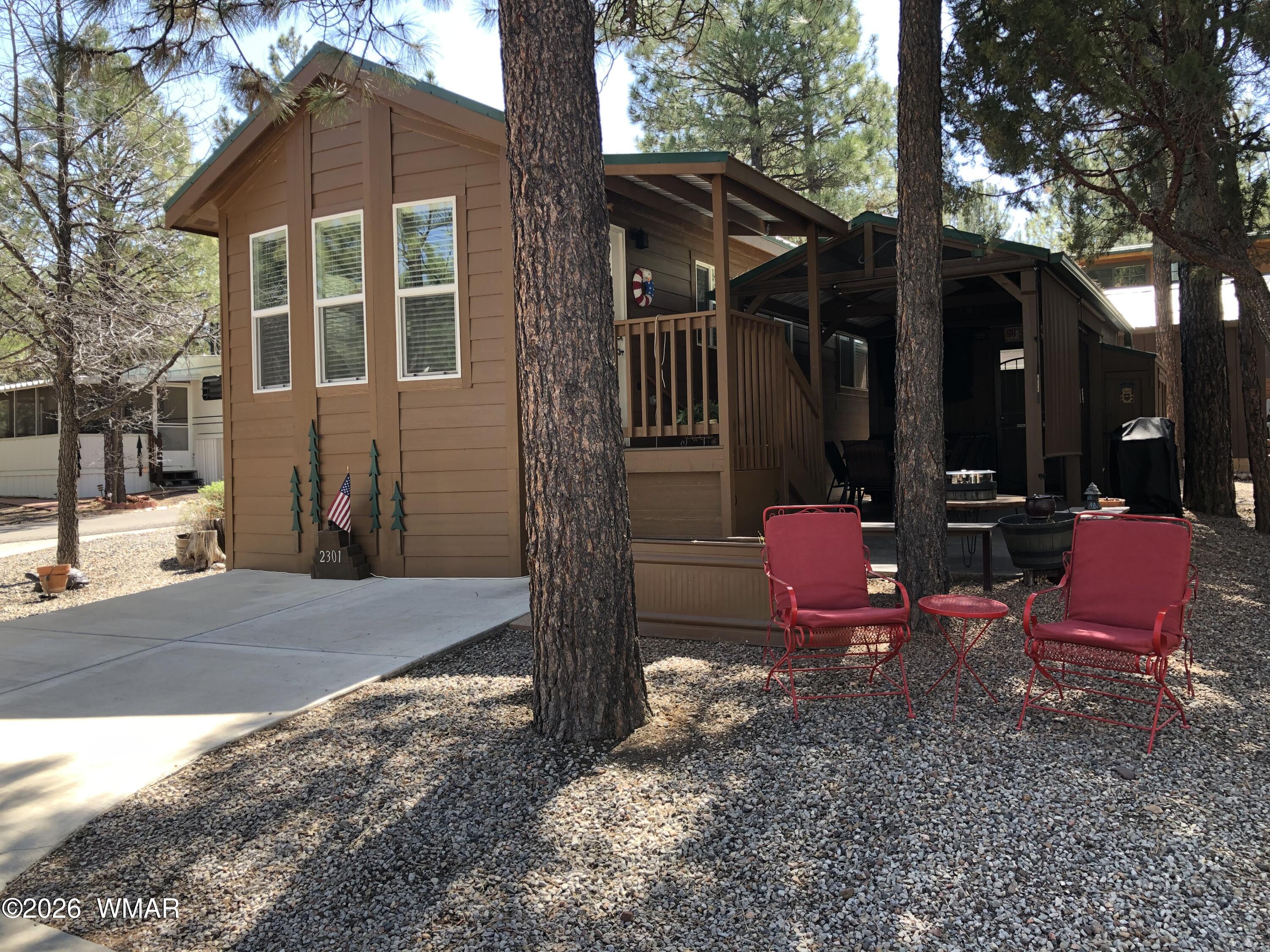 2301 Turtle Creek Road Show Low, AZ 85901 - Photo 1 of 35 a view of a wooden house with a yard