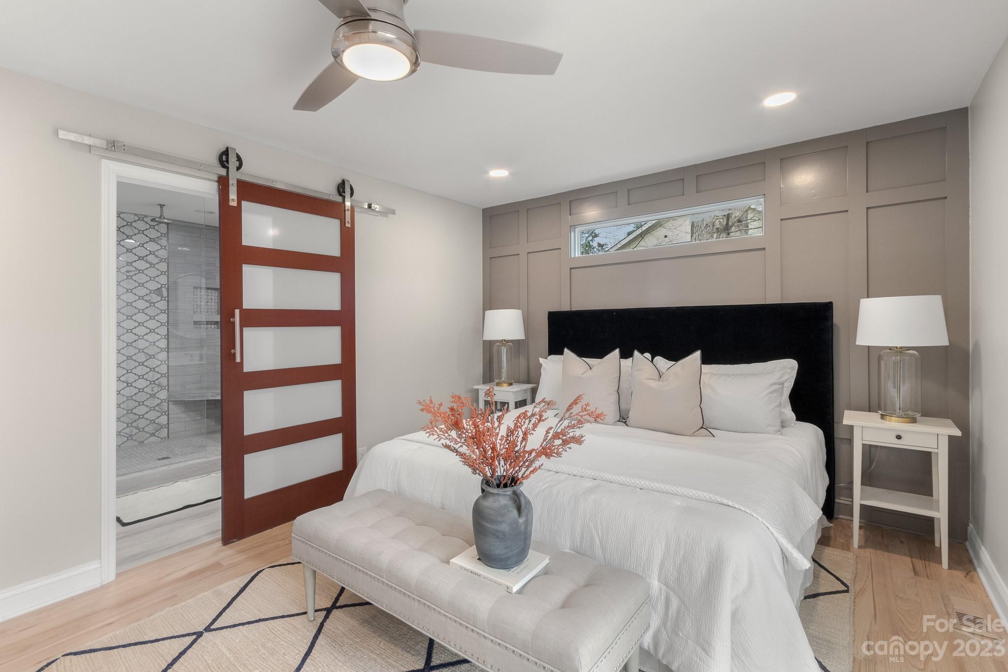 7022 Chelsea Day Lane Tega Cay, SC 29708 - Photo 16 of 48 a bed room with a bed and a potted plant