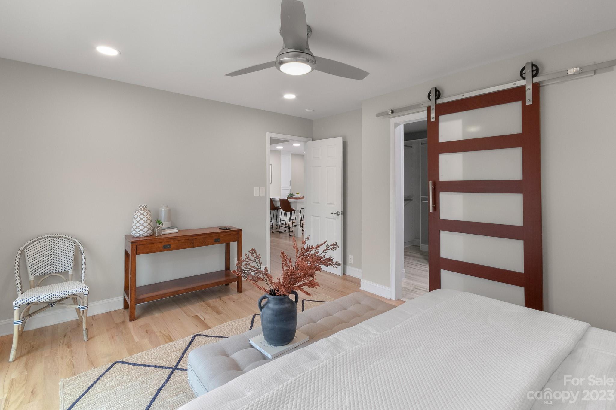 7022 Chelsea Day Lane Tega Cay, SC 29708 - Photo 18 of 48 a bedroom with furniture and a chandelier