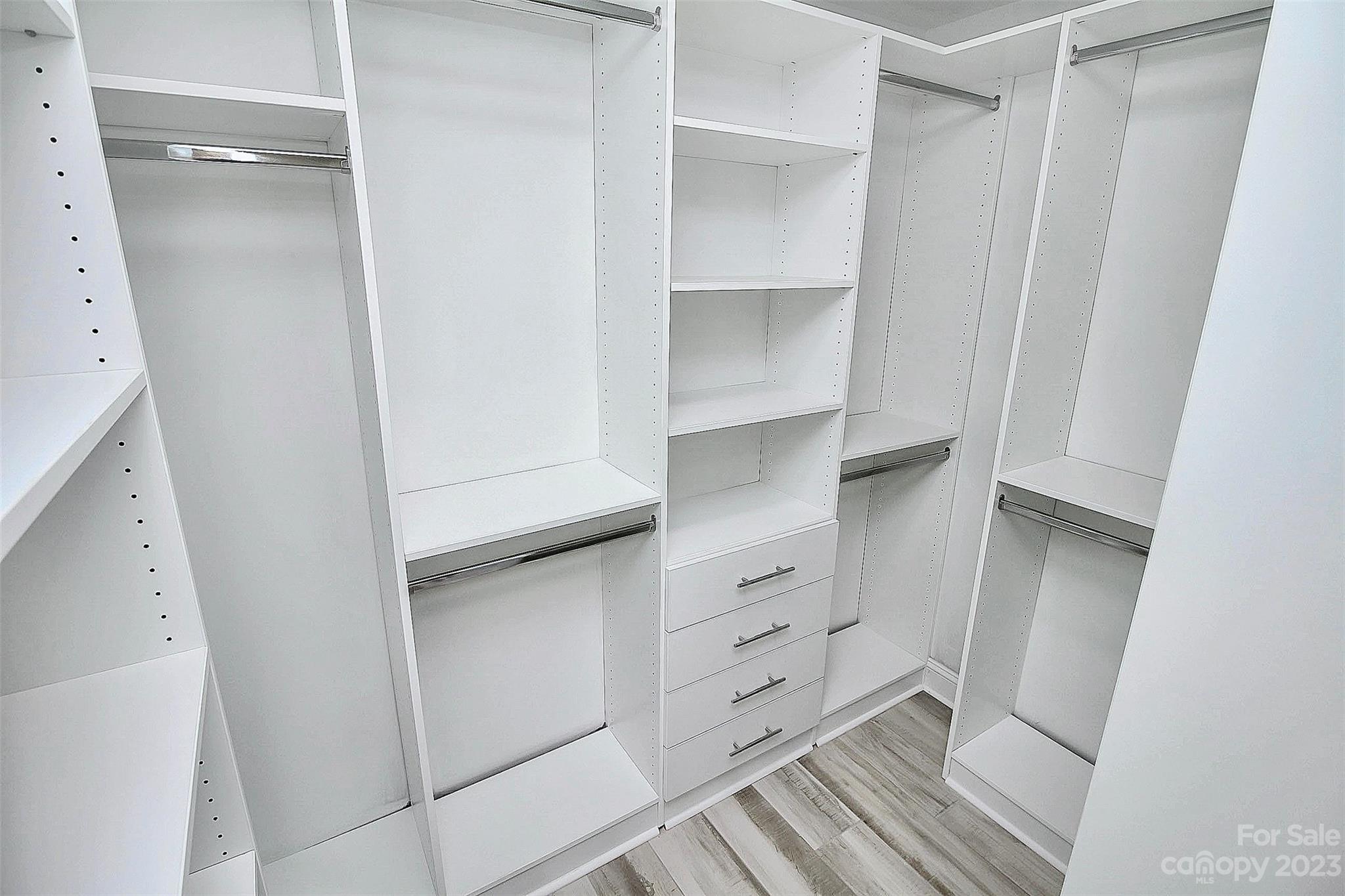 7022 Chelsea Day Lane Tega Cay, SC 29708 - Photo 21 of 48 a view of walk in closet with empty racks