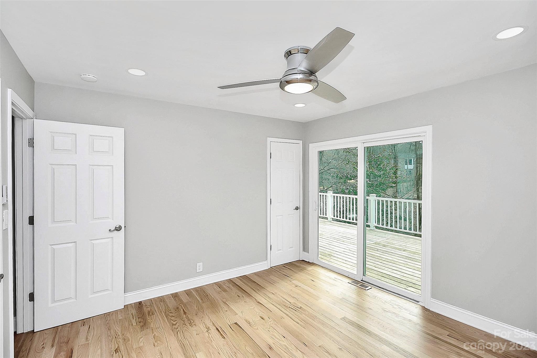 7022 Chelsea Day Lane Tega Cay, SC 29708 - Photo 22 of 48 an empty room with wooden floor fan and windows