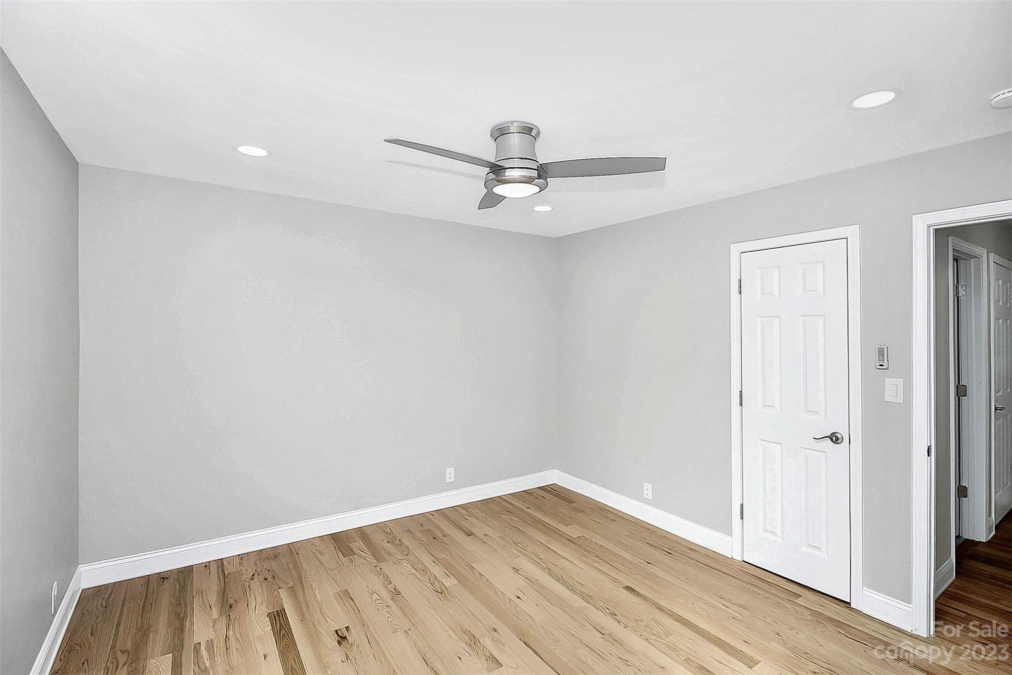 7022 Chelsea Day Lane Tega Cay, SC 29708 - Photo 23 of 48 wooden floor in an empty room with a window