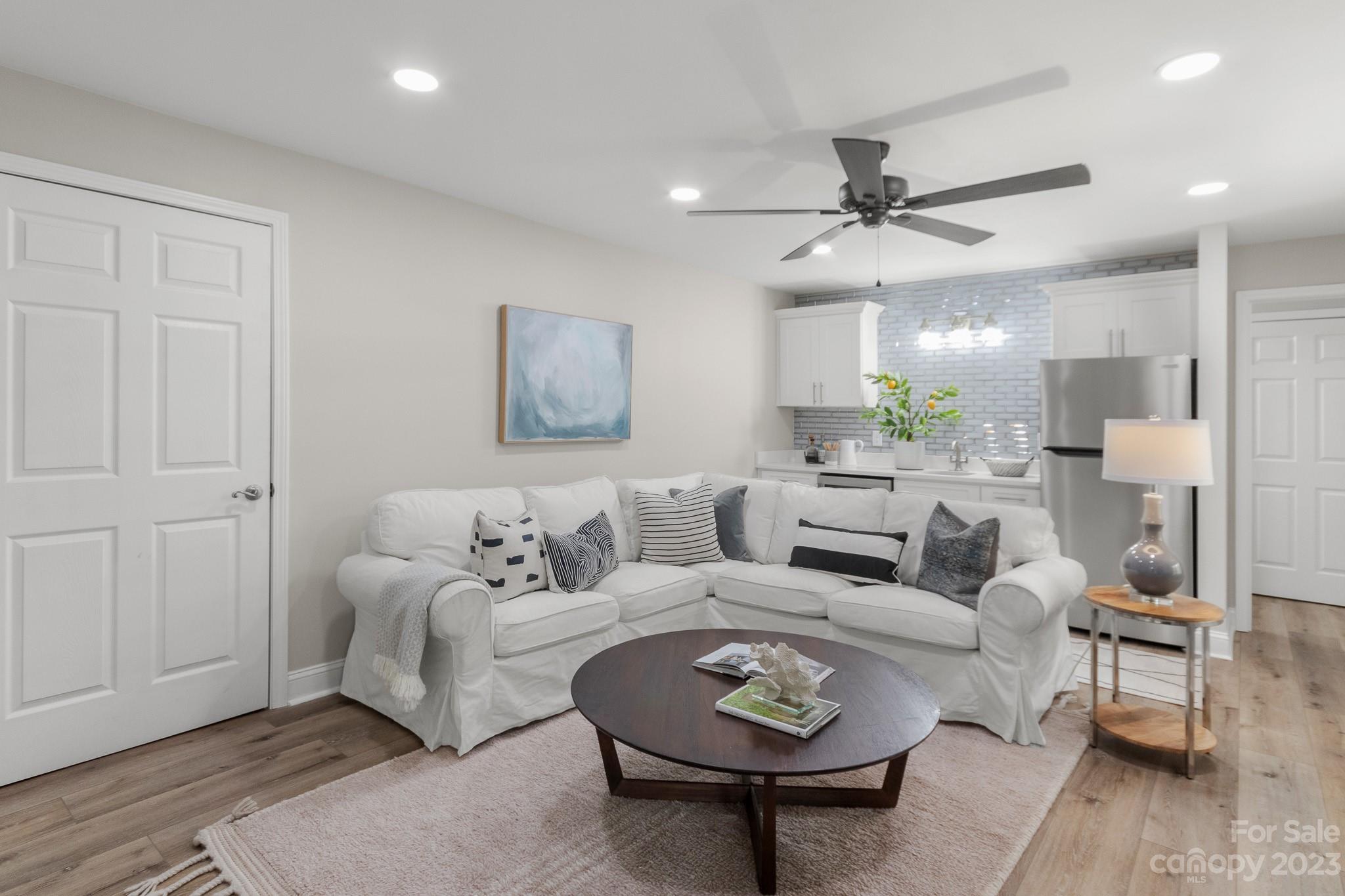 7022 Chelsea Day Lane Tega Cay, SC 29708 - Photo 28 of 48 a living room with furniture a rug and a chandelier