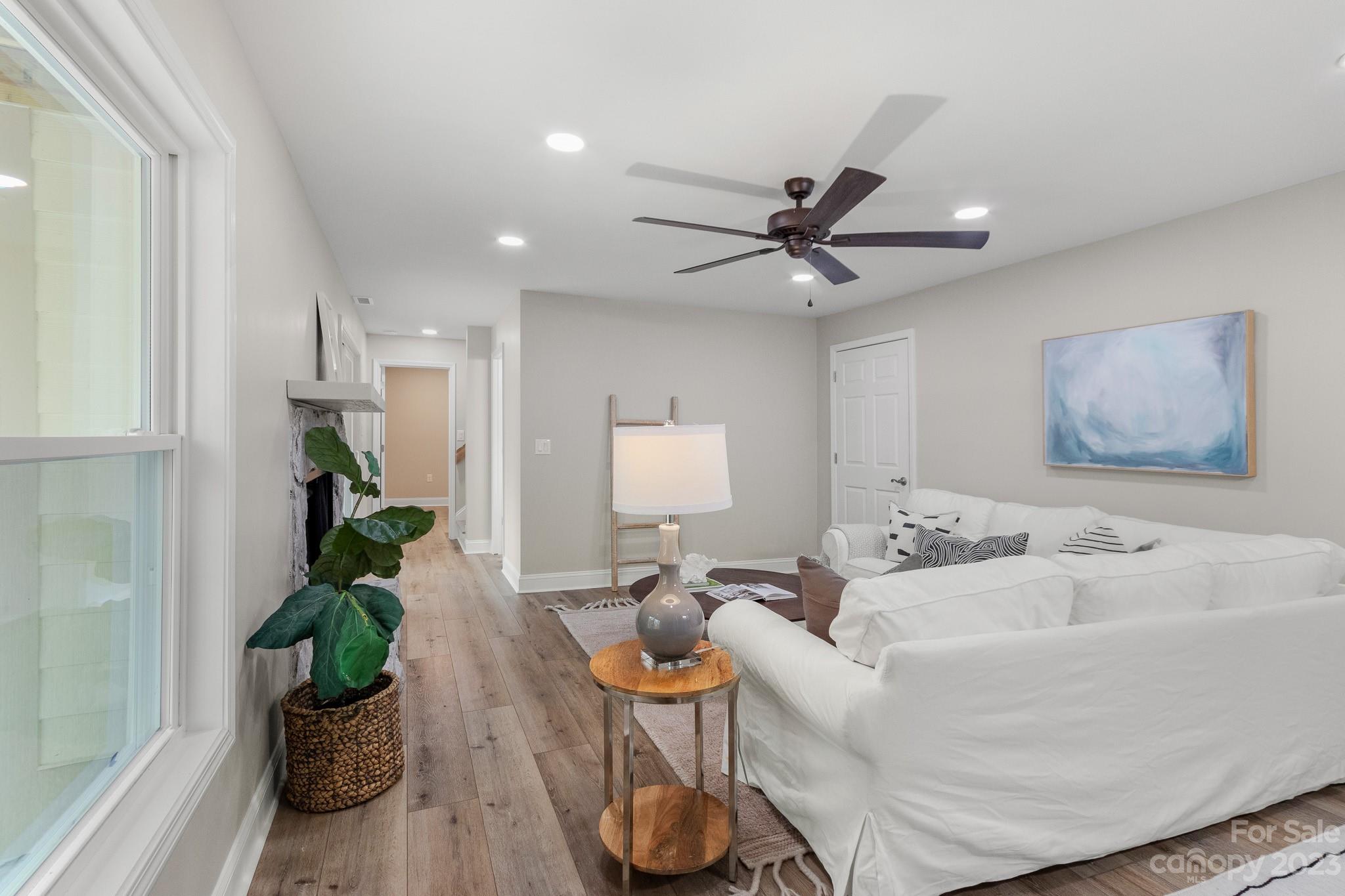7022 Chelsea Day Lane Tega Cay, SC 29708 - Photo 30 of 48 a living room with furniture flowers and a window