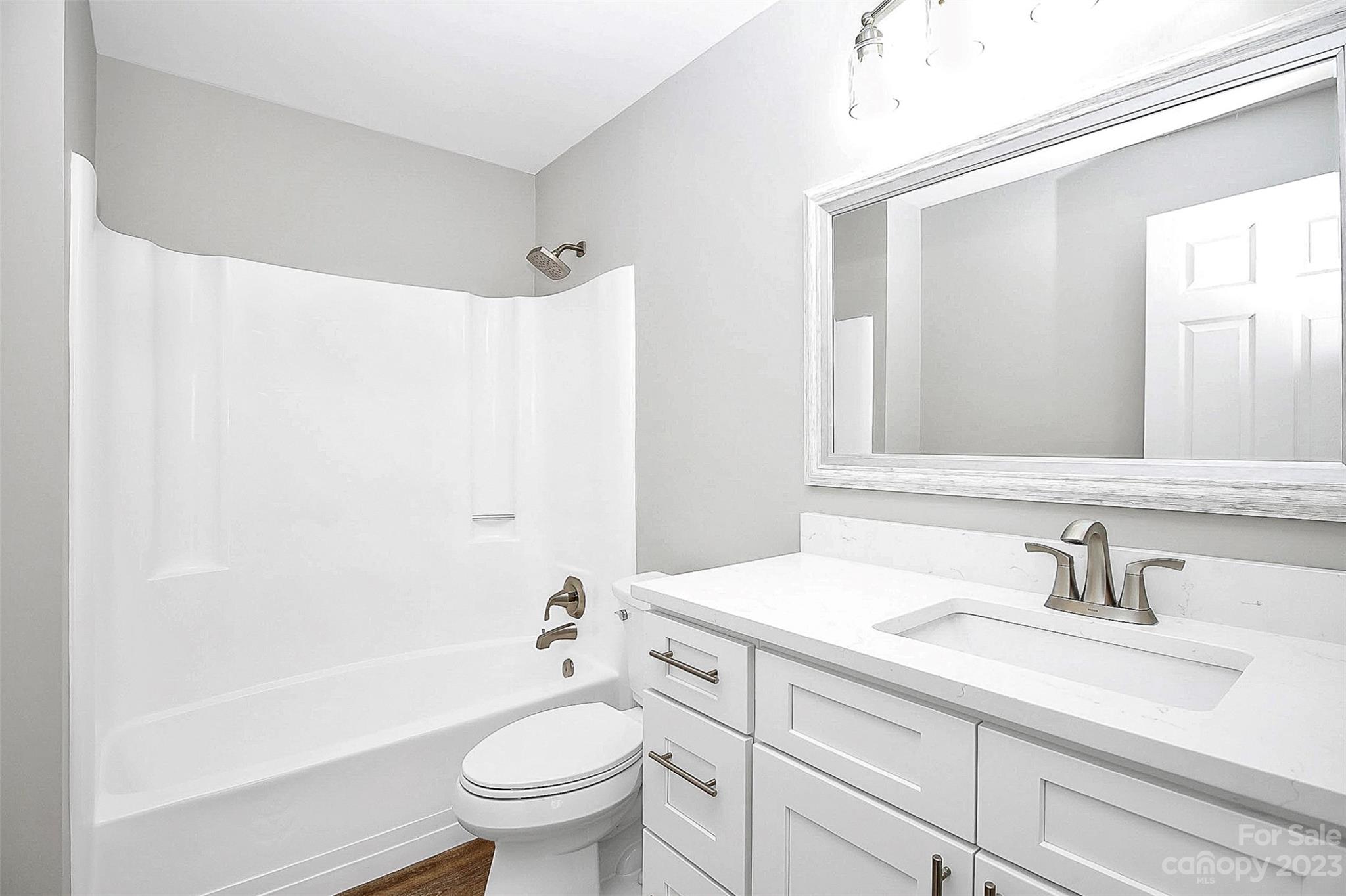 7022 Chelsea Day Lane Tega Cay, SC 29708 - Photo 34 of 48 a bathroom with a sink a toilet and a large mirror