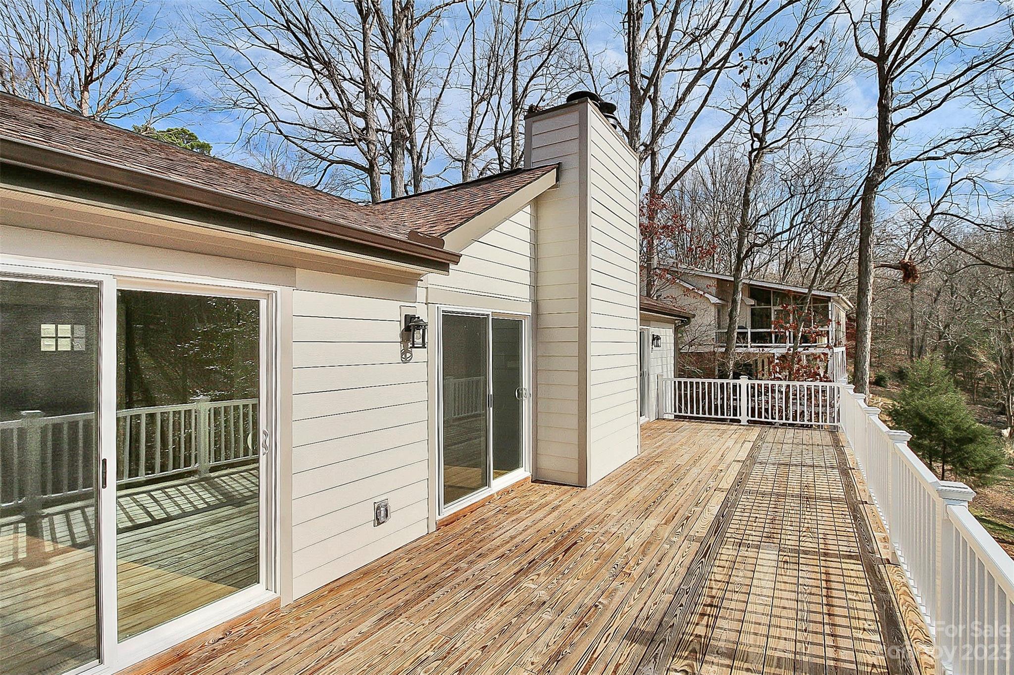 7022 Chelsea Day Lane Tega Cay, SC 29708 - Photo 36 of 48 a view of a balcony with wooden floor and fence and a large tree