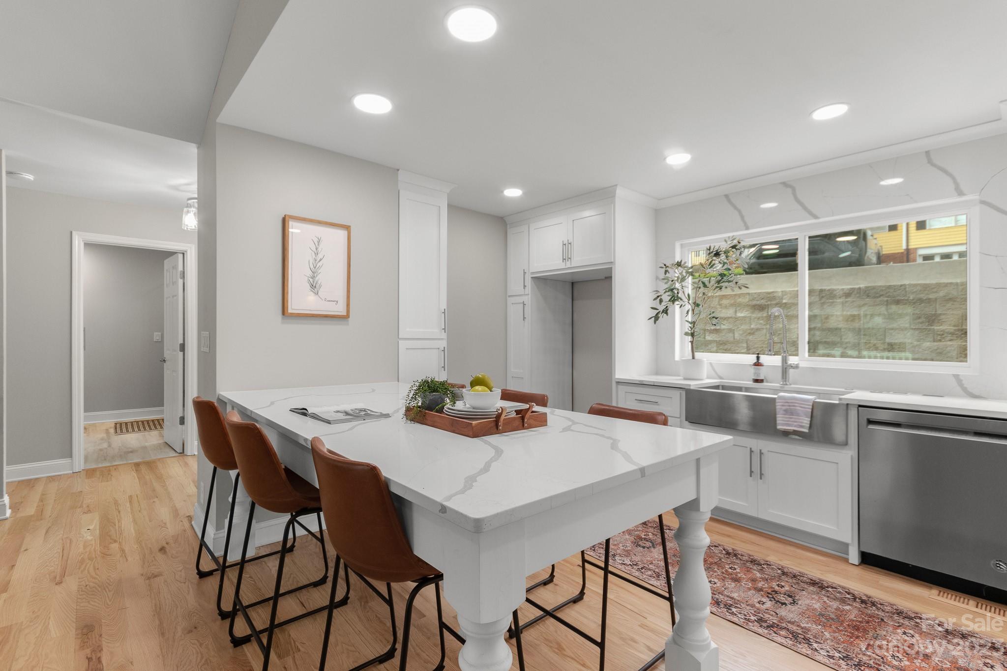 7022 Chelsea Day Lane Tega Cay, SC 29708 - Photo 4 of 48 a kitchen with a table and chairs in it