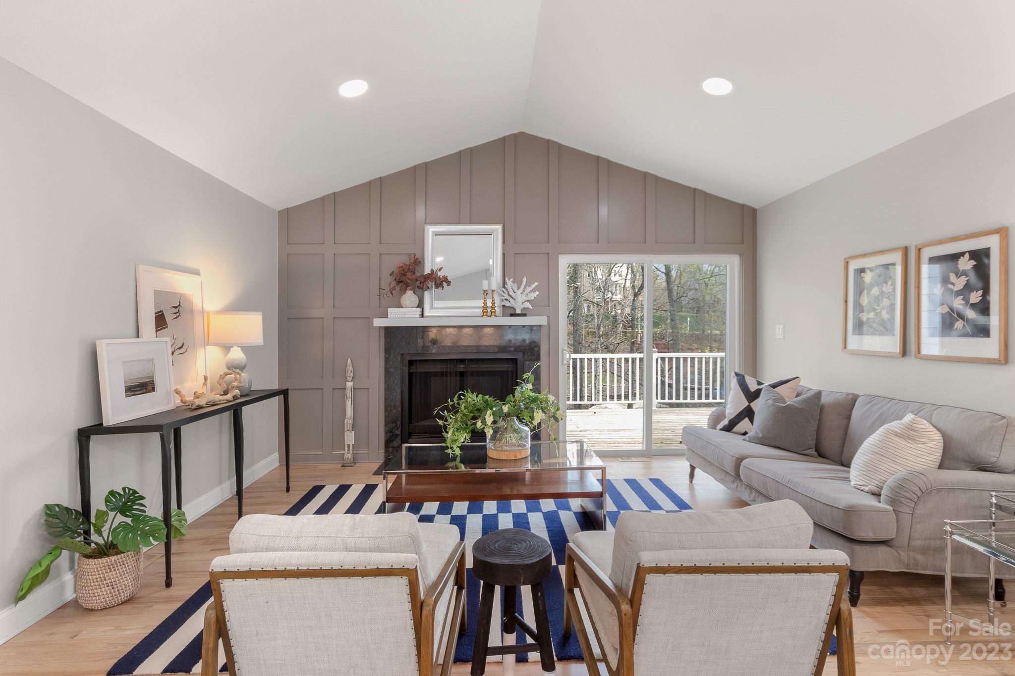 7022 Chelsea Day Lane Tega Cay, SC 29708 - Photo 6 of 48 a living room with furniture a fireplace and a potted plant