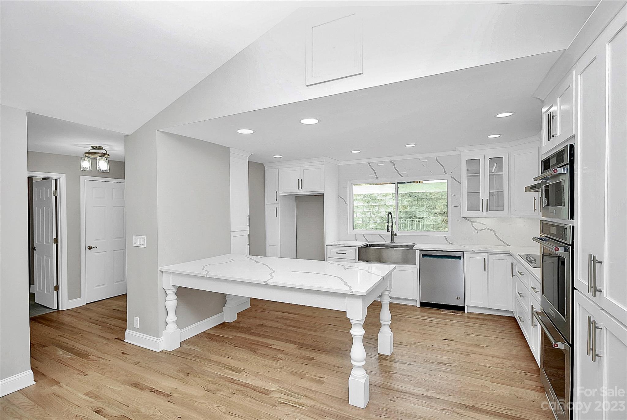 7022 Chelsea Day Lane Tega Cay, SC 29708 - Photo 8 of 48 a room with lots of wooden furniture and windows