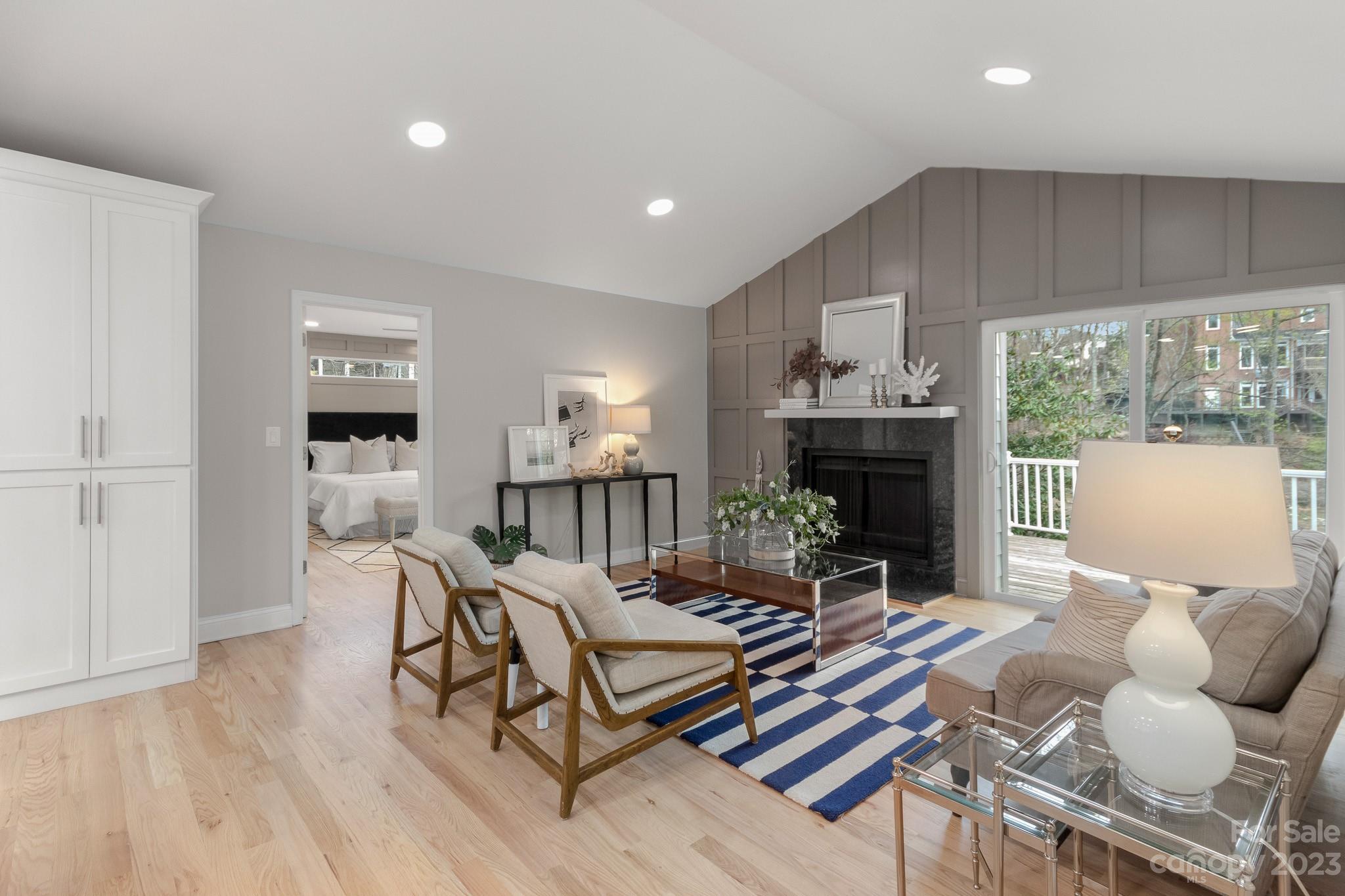 7022 Chelsea Day Lane Tega Cay, SC 29708 - Photo 9 of 48 a living room with furniture a fireplace and a floor to ceiling window