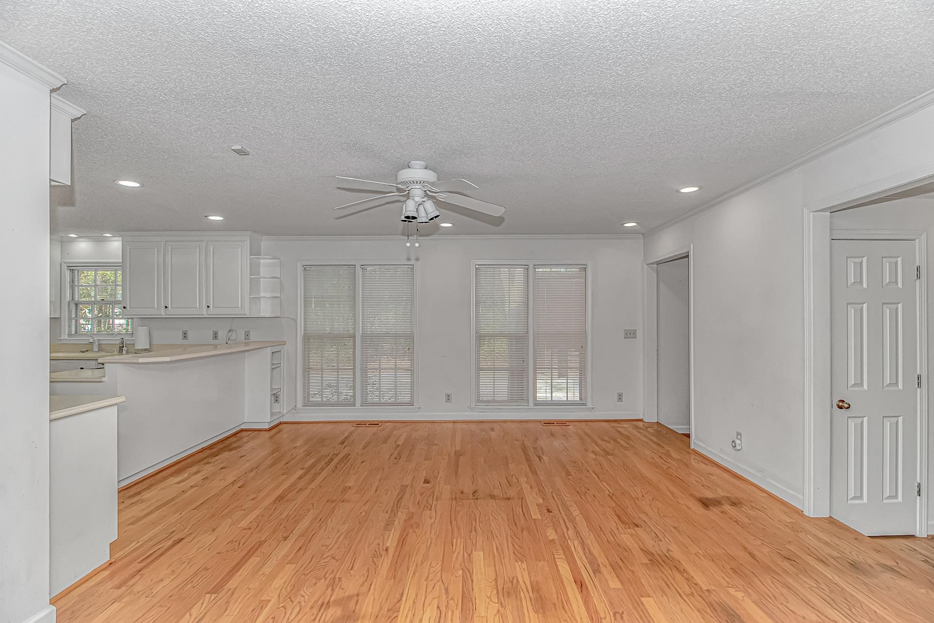 119 University Circle Conway, SC 29526 - Photo 11 of 40 Unfurnished living room with recessed lighting, a textured ceiling, light wood-style floors, a ceiling fan, and ornamental molding
