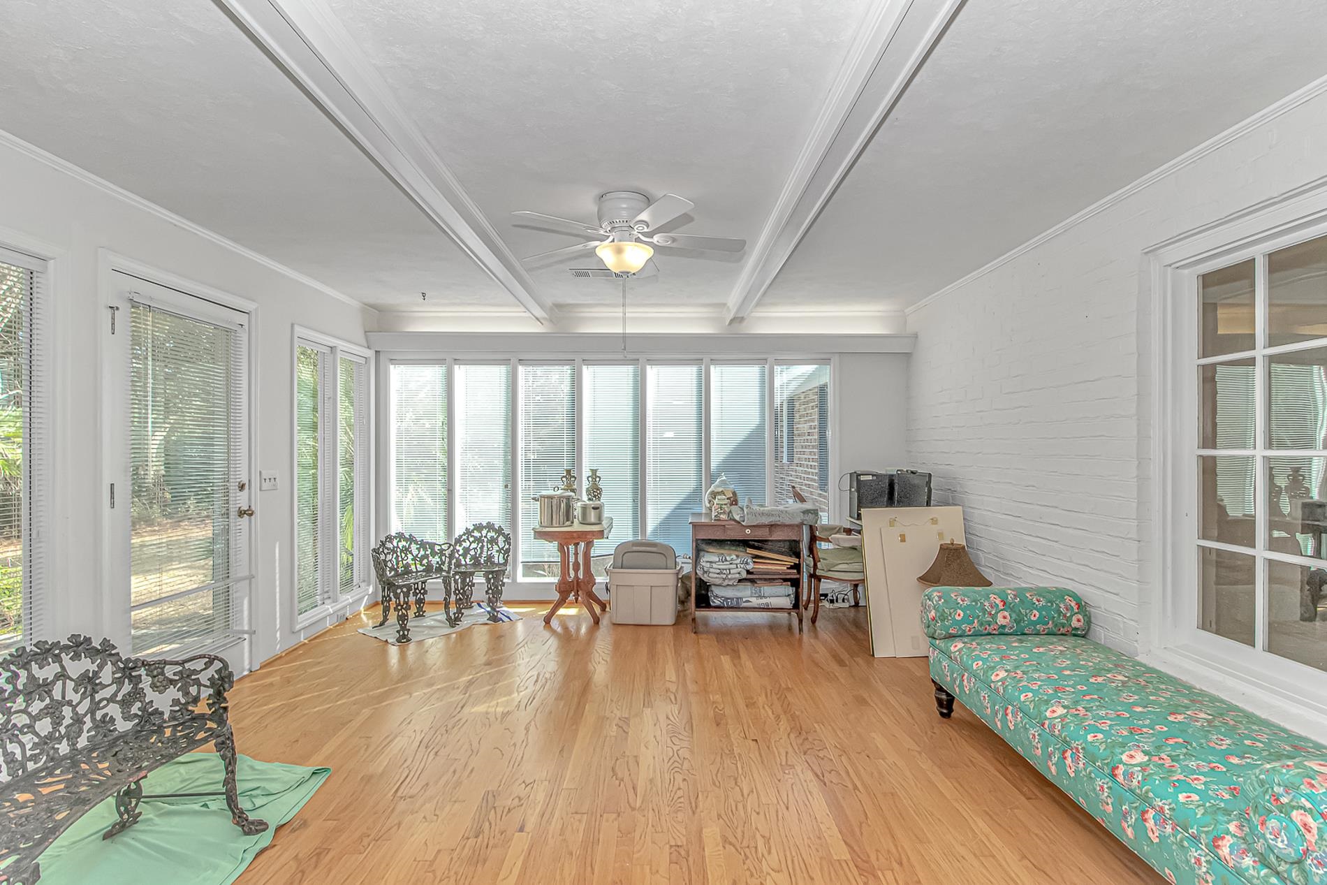 119 University Circle Conway, SC 29526 - Photo 14 of 40 Sunroom / solarium with brick wall, wood finished floors, beamed ceiling, and ornamental molding