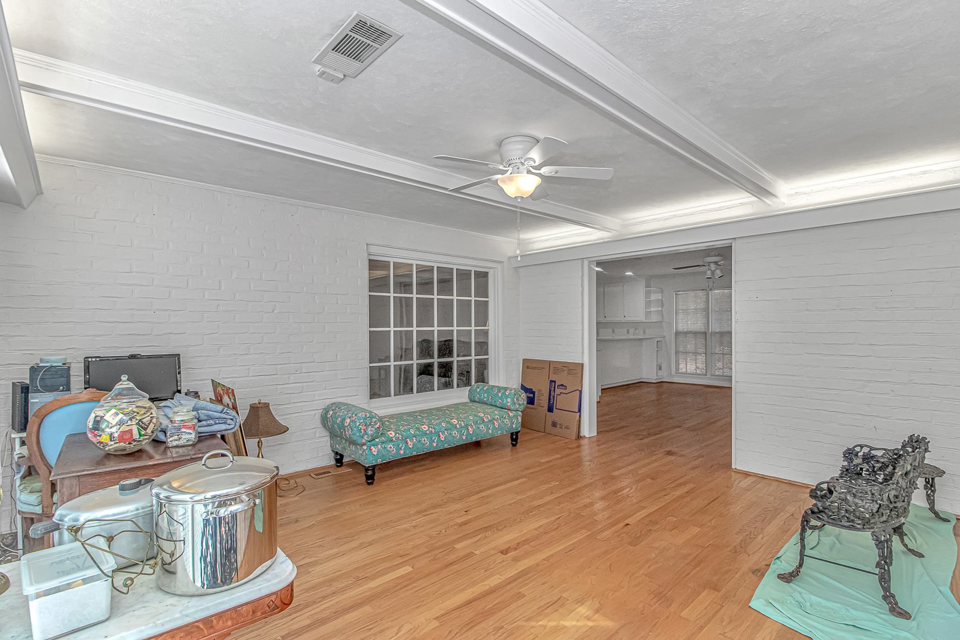 119 University Circle Conway, SC 29526 - Photo 15 of 40 Sitting room with brick wall, beamed ceiling, wood finished floors, and ceiling fan