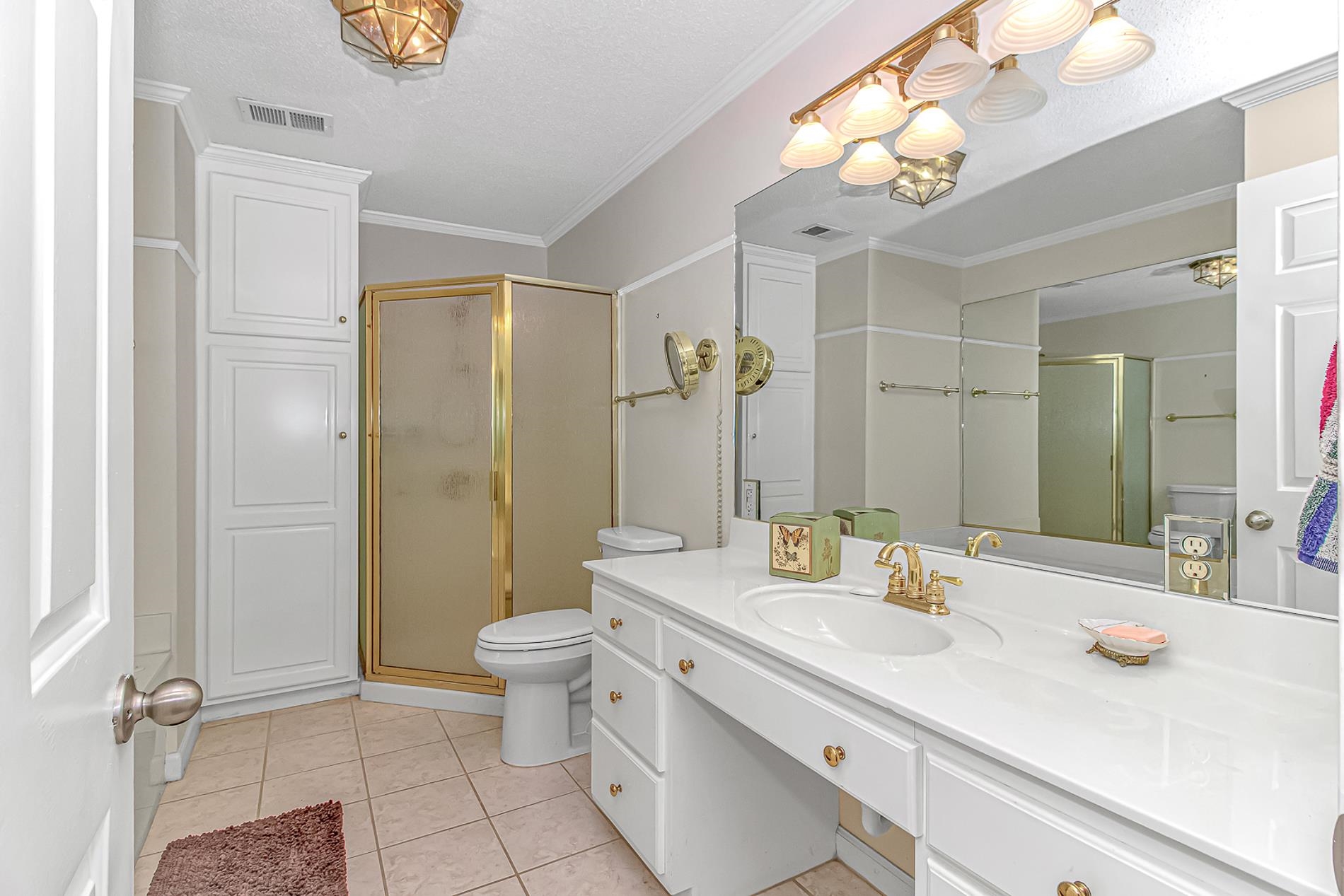 119 University Circle Conway, SC 29526 - Photo 19 of 40 Full bathroom with a shower stall, crown molding, vanity, a textured ceiling, and light tile patterned flooring