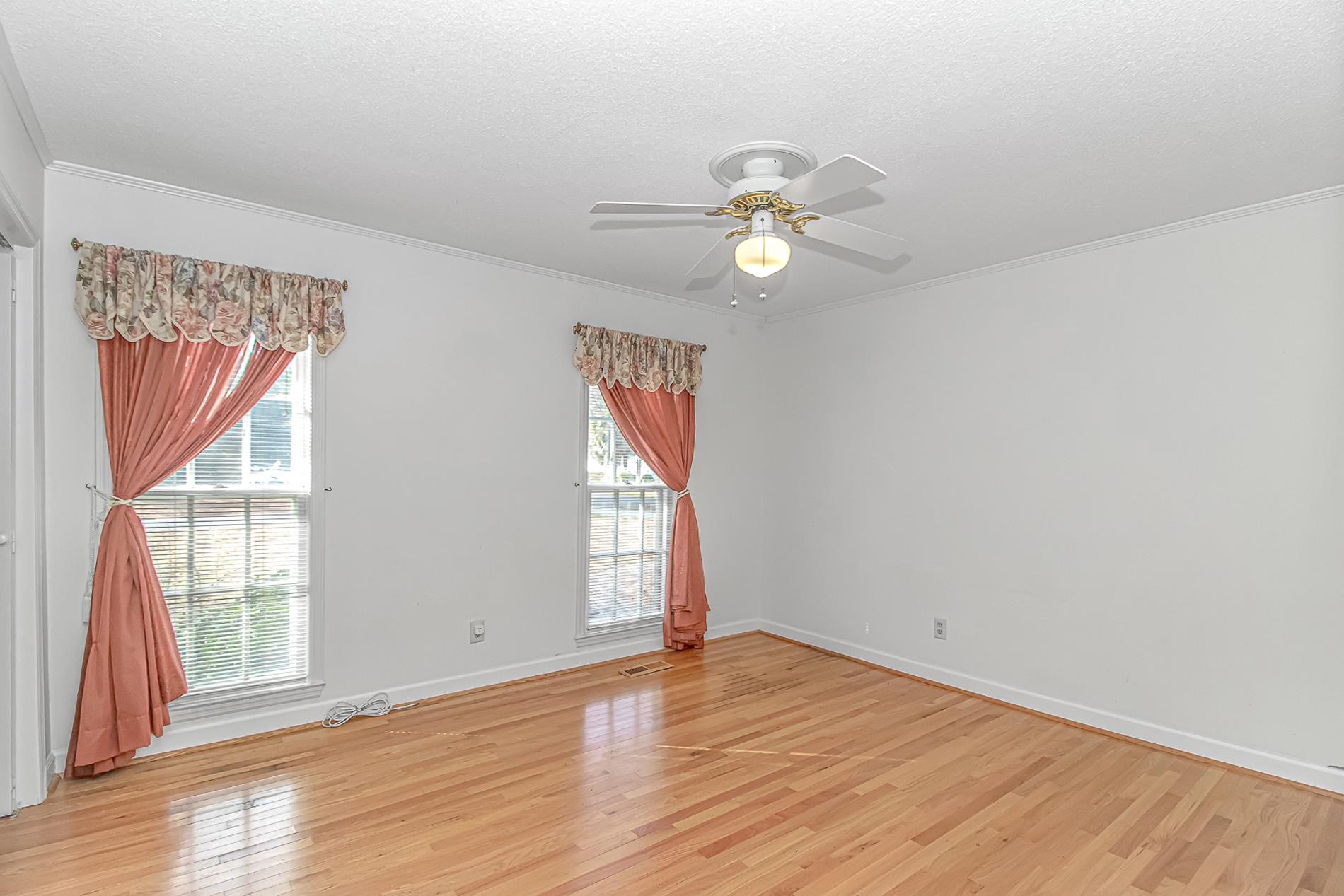 119 University Circle Conway, SC 29526 - Photo 22 of 40 Empty room featuring light wood finished floors, a ceiling fan, ornamental molding, and a textured ceiling