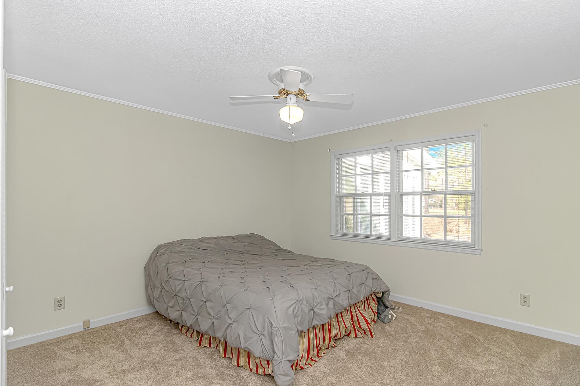 119 University Circle Conway, SC 29526 - Photo 25 of 40 Carpeted bedroom featuring crown molding, ceiling fan, and a textured ceiling
