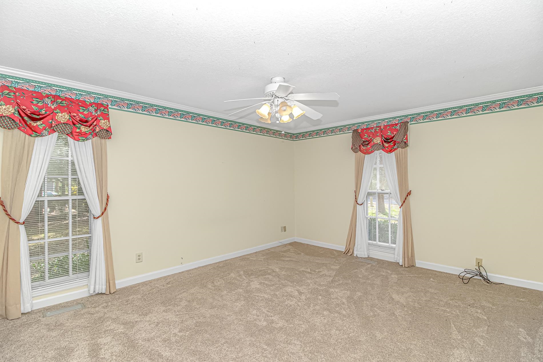 119 University Circle Conway, SC 29526 - Photo 27 of 40 Empty room featuring a ceiling fan, light carpet, crown molding, and a textured ceiling