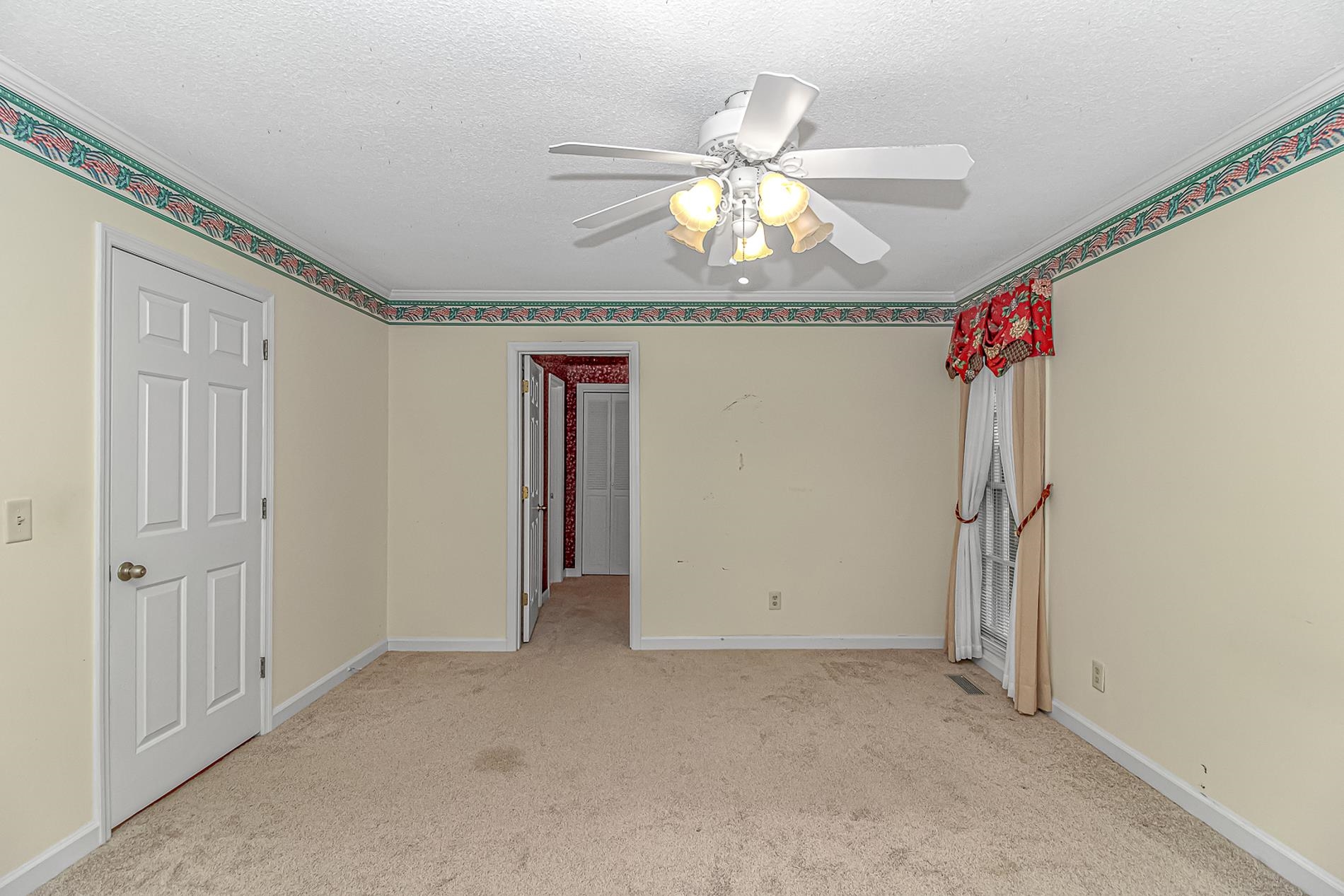 119 University Circle Conway, SC 29526 - Photo 28 of 40 Unfurnished room featuring crown molding, light colored carpet, a textured ceiling, and ceiling fan