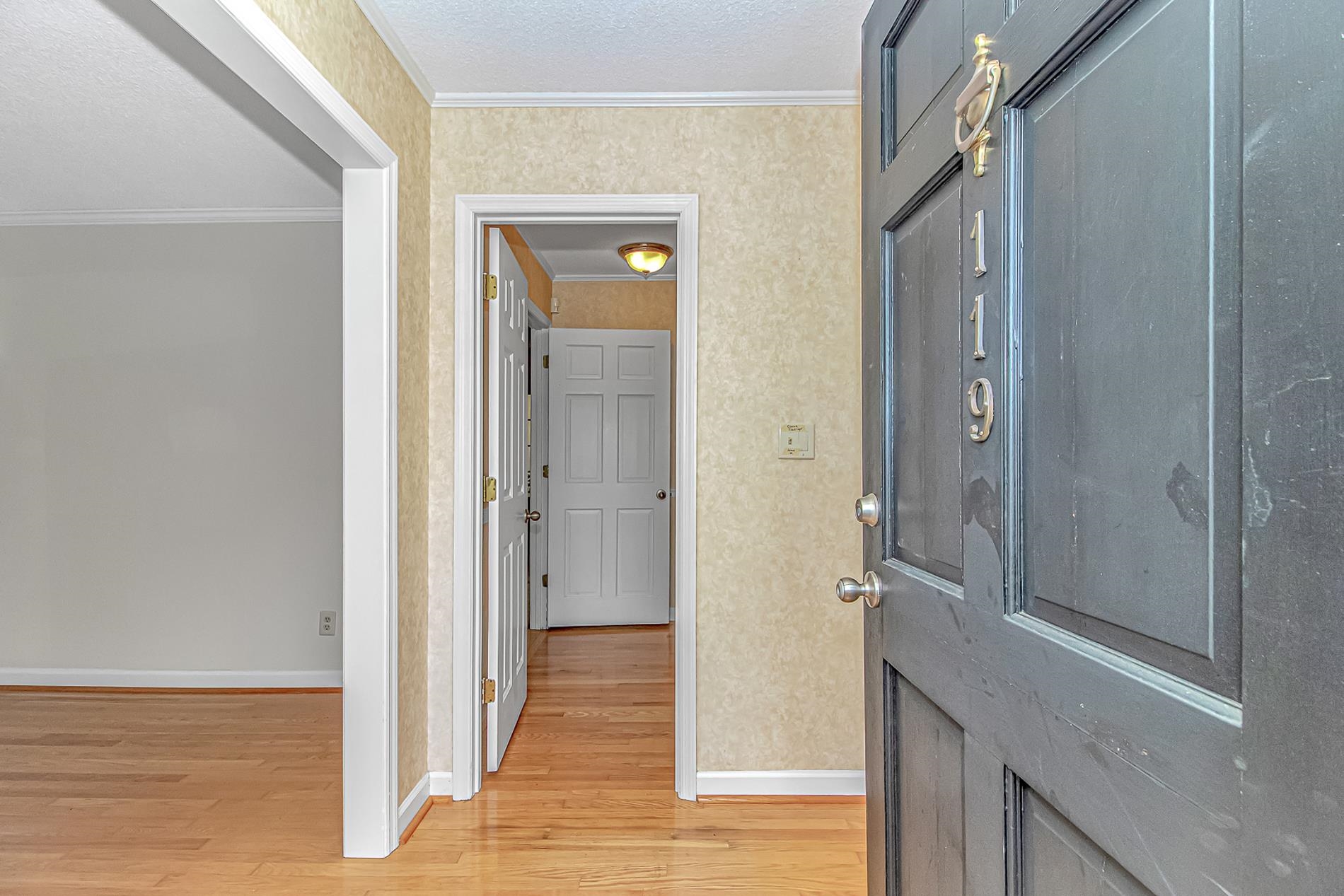 119 University Circle Conway, SC 29526 - Photo 3 of 40 Foyer with crown molding, light wood-type flooring, and wallpapered walls