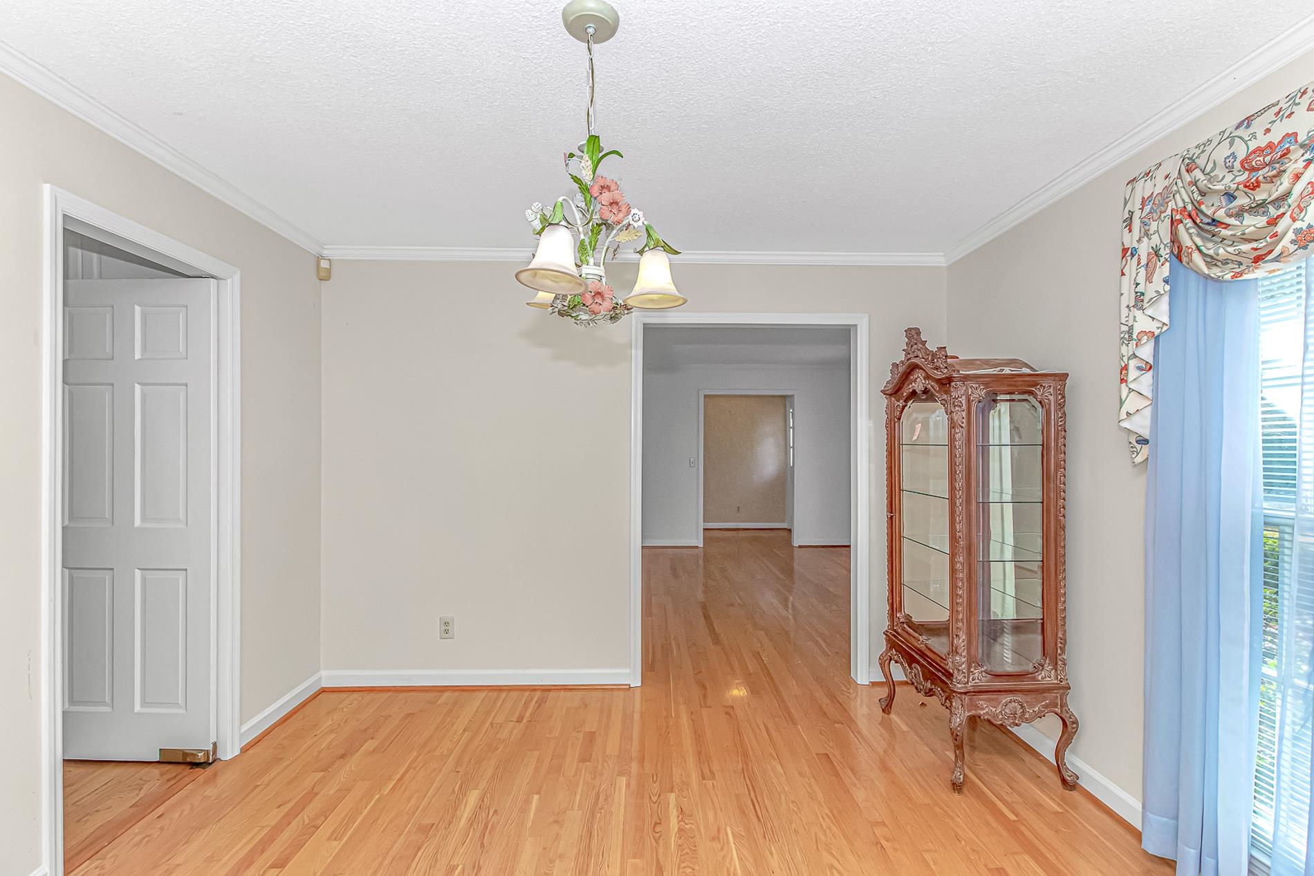 119 University Circle Conway, SC 29526 - Photo 7 of 40 Unfurnished dining area with a textured ceiling, light wood finished floors, a chandelier, and crown molding