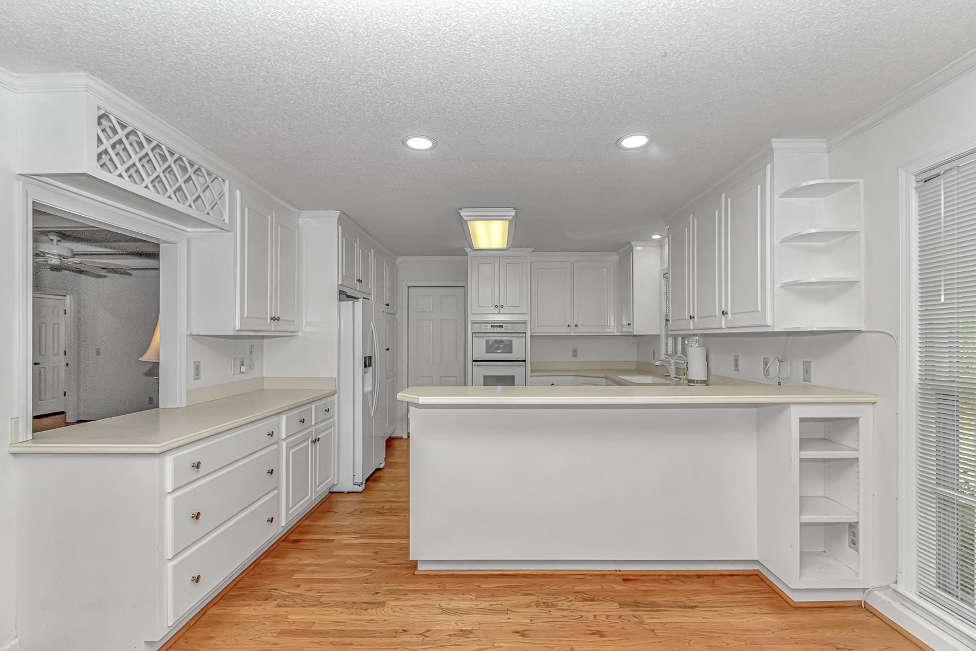 119 University Circle Conway, SC 29526 - Photo 10 of 40 Kitchen featuring open shelves, a peninsula, white cabinets, a textured ceiling, and recessed lighting