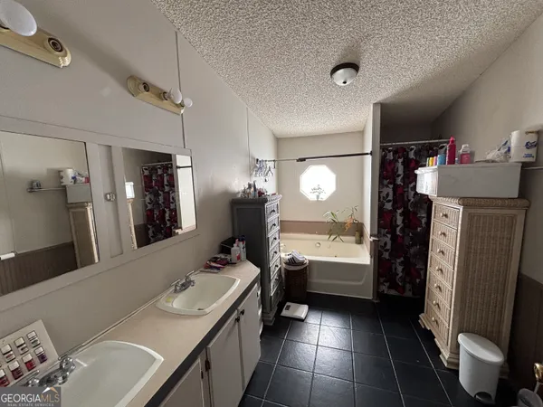 a bathroom with a sink a toilet and a large mirror