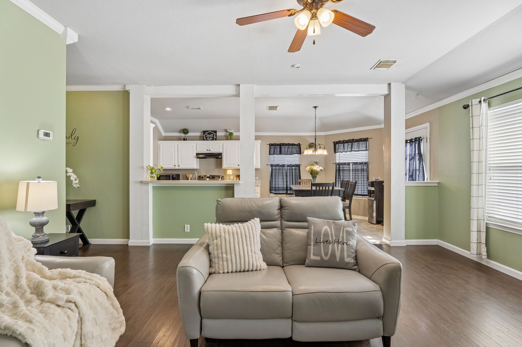 159 Invierno Street Kyle, TX 78640 - Photo 13 of 40 The living room connects seamlessly to the kitchen and dining area while still maintaining its own distinctive space.