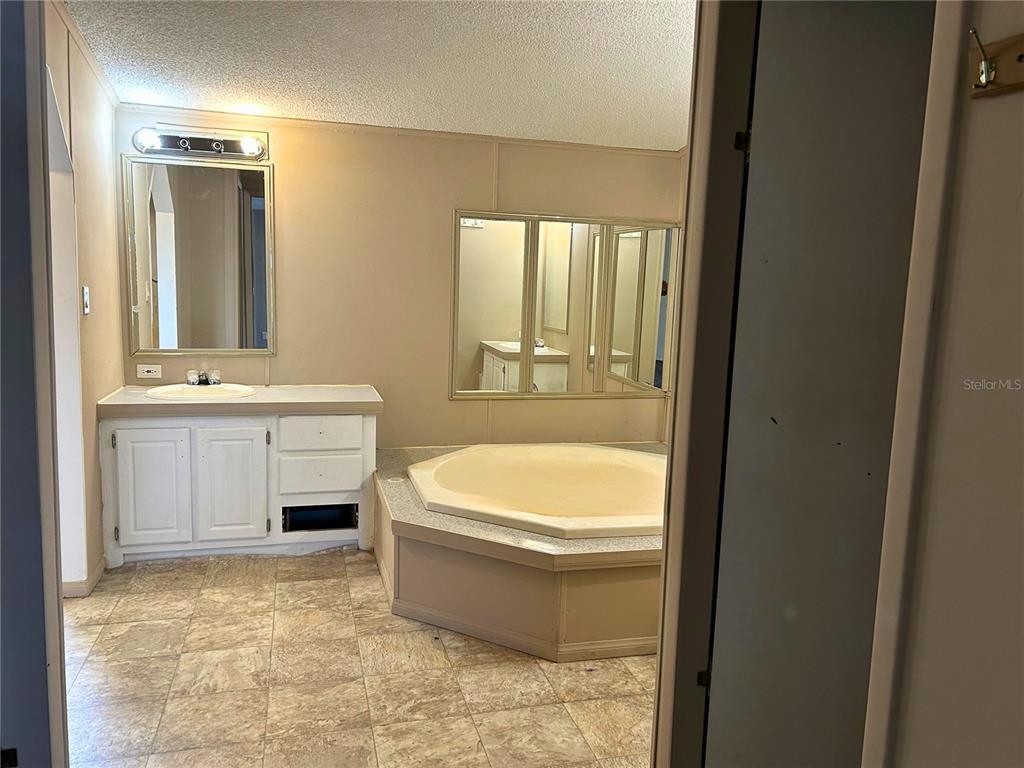 9867 Jerome Drive New Port Richey, FL 34654 - Photo 11 of 30 a bathroom with a sink a toilet and tub