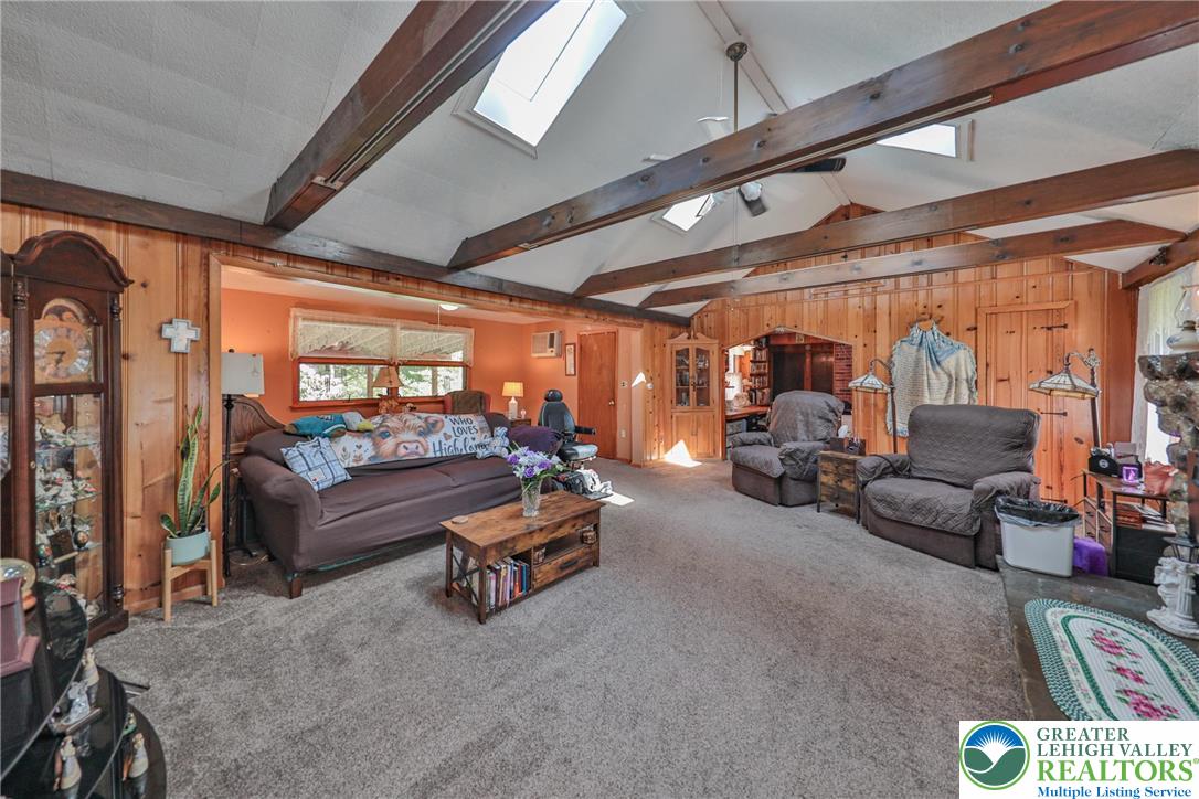 331 Cranberry Creek Road Cresco, PA 18326 - Photo 18 of 95 Natural wood paneling and exposed beams create a cozy, cabin-like ambiance throughout the living area.