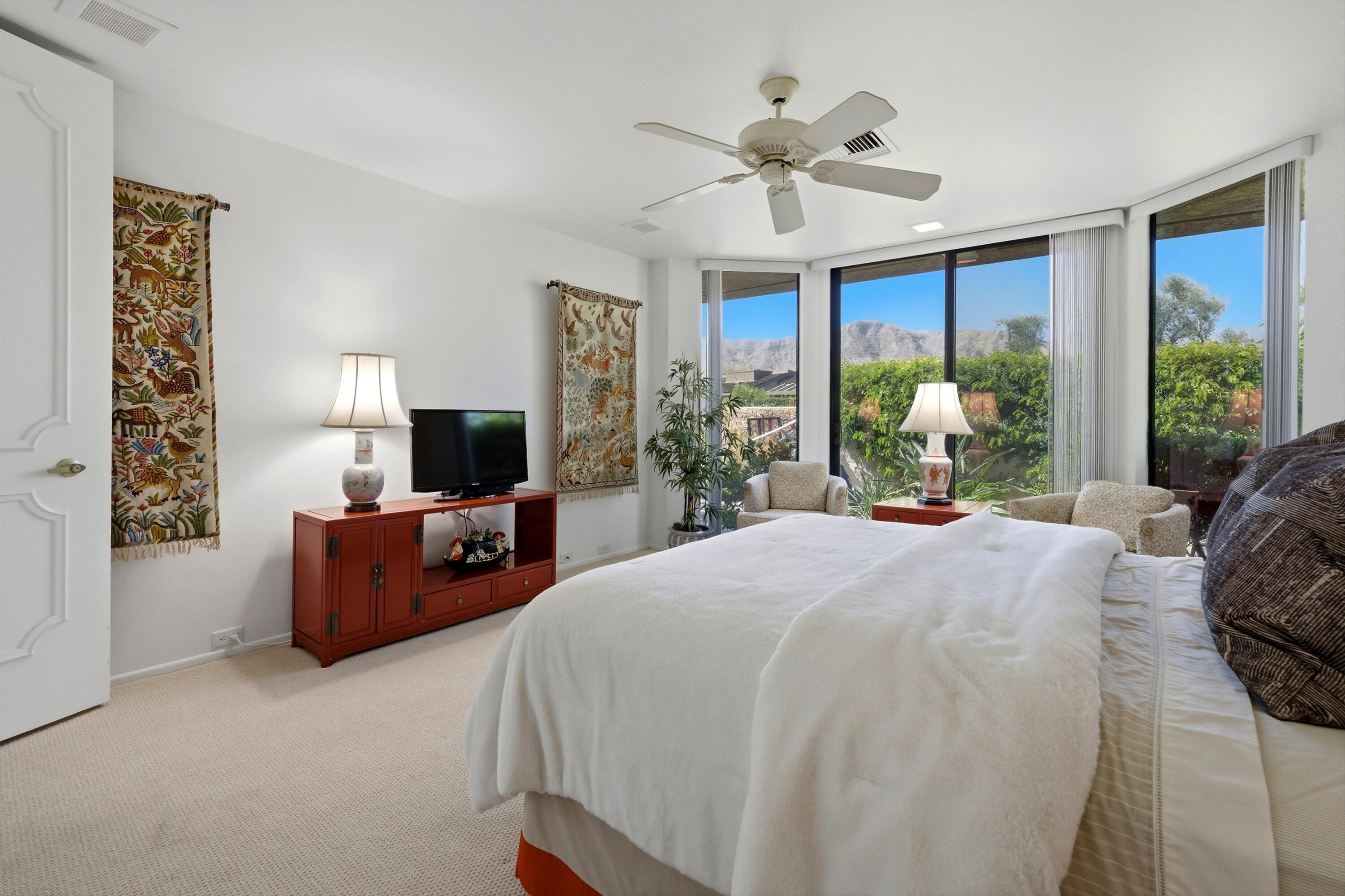 23 Mt Holyoke Drive Rancho Mirage, CA 92270 - Photo 28 of 50 a spacious bedroom with a large bed and a large window