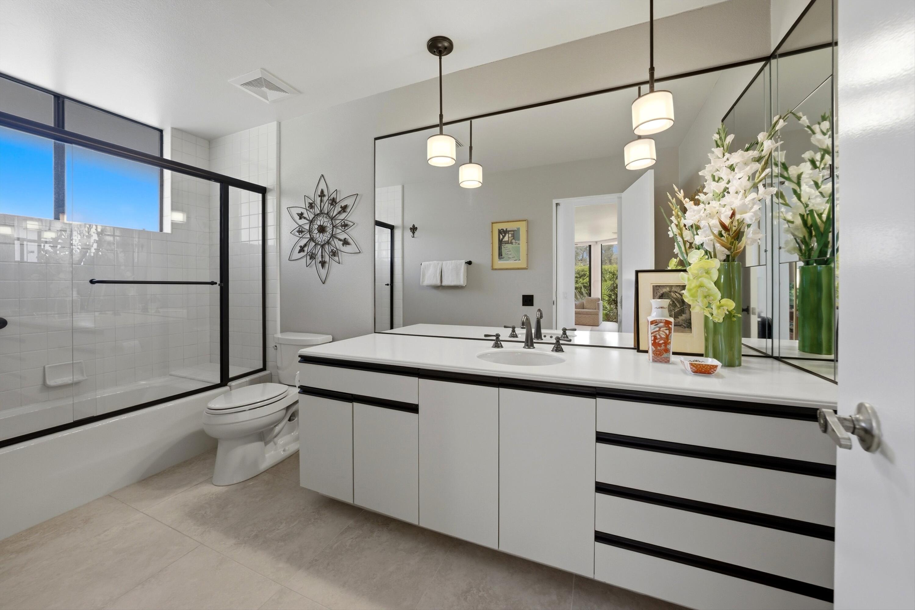 23 Mt Holyoke Drive Rancho Mirage, CA 92270 - Photo 29 of 50 a bathroom with a double vanity sink a toilet a mirror and shower