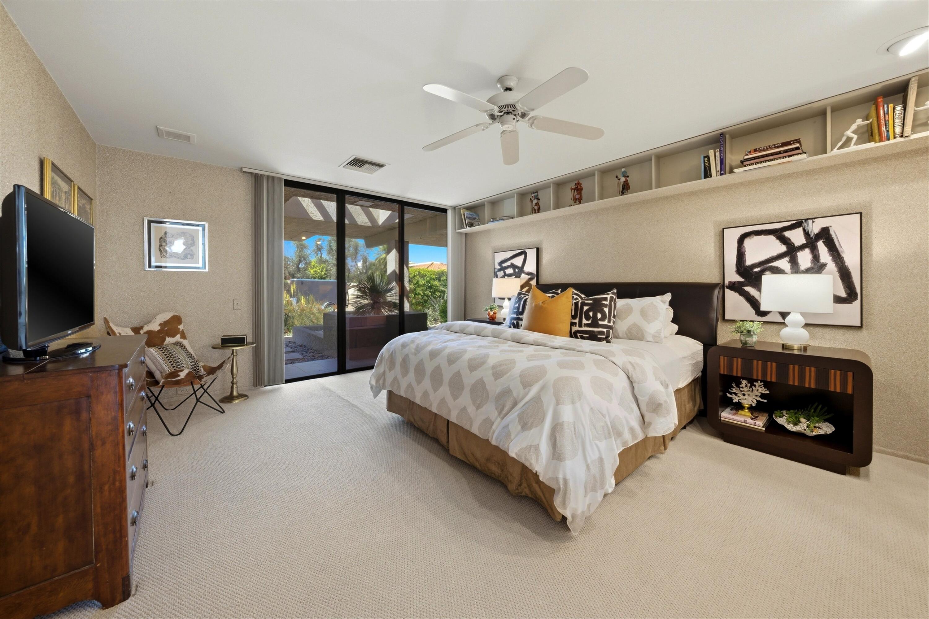 23 Mt Holyoke Drive Rancho Mirage, CA 92270 - Photo 30 of 50 a bedroom with a bed and a flat tv screen on the dresser