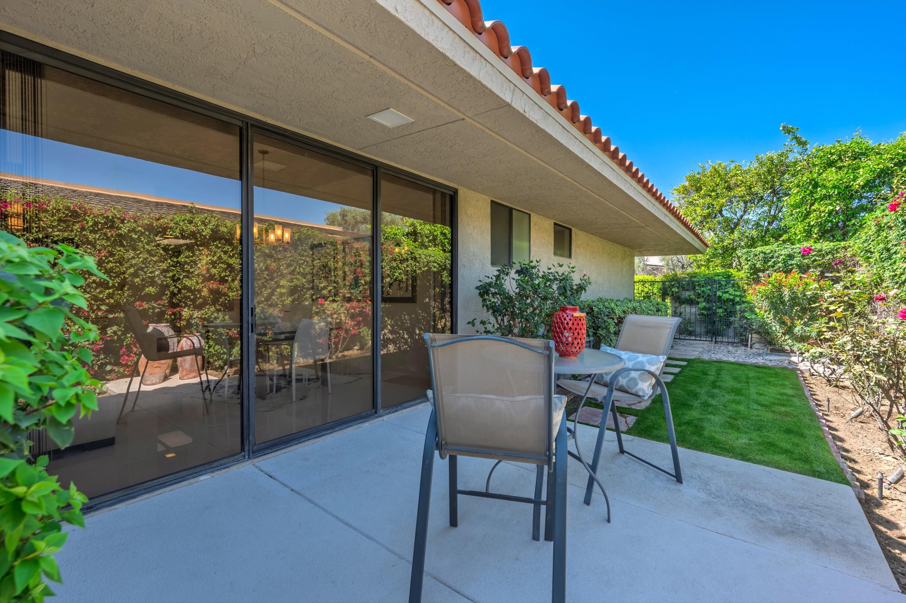 23 Mt Holyoke Drive Rancho Mirage, CA 92270 - Photo 45 of 50 a view of a patio with a table and chairs and potted plants