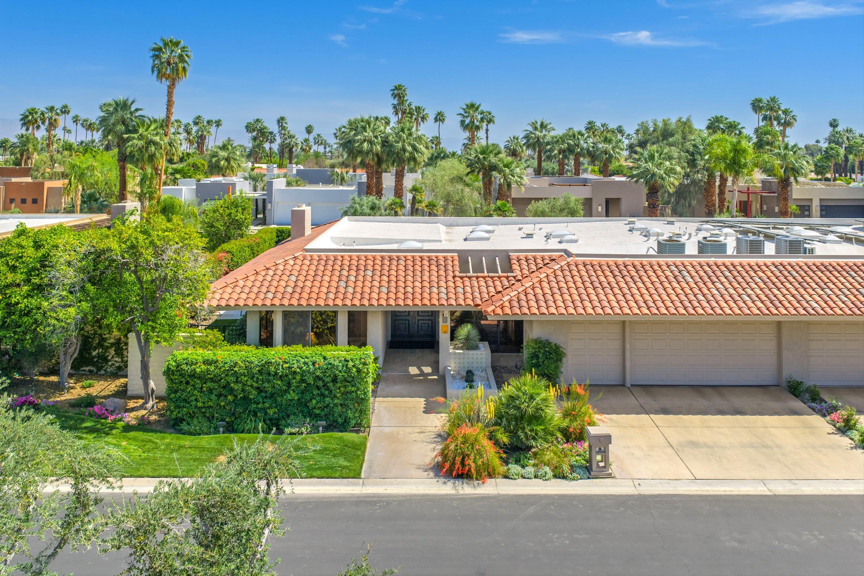 23 Mt Holyoke Drive Rancho Mirage, CA 92270 - Photo 47 of 50 a front view of a house with a yard and potted plants