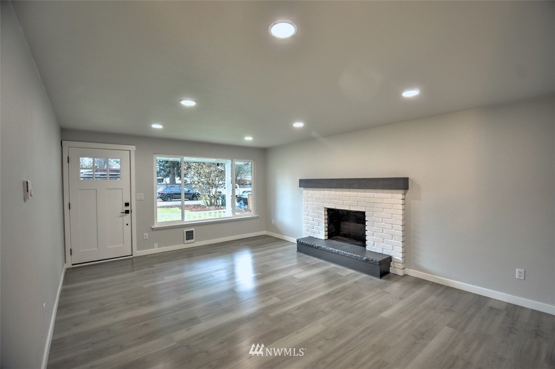 10330 185th Avenue Southwest Rochester, WA 98579 - Photo 5 of 22 an empty room with windows and fireplace