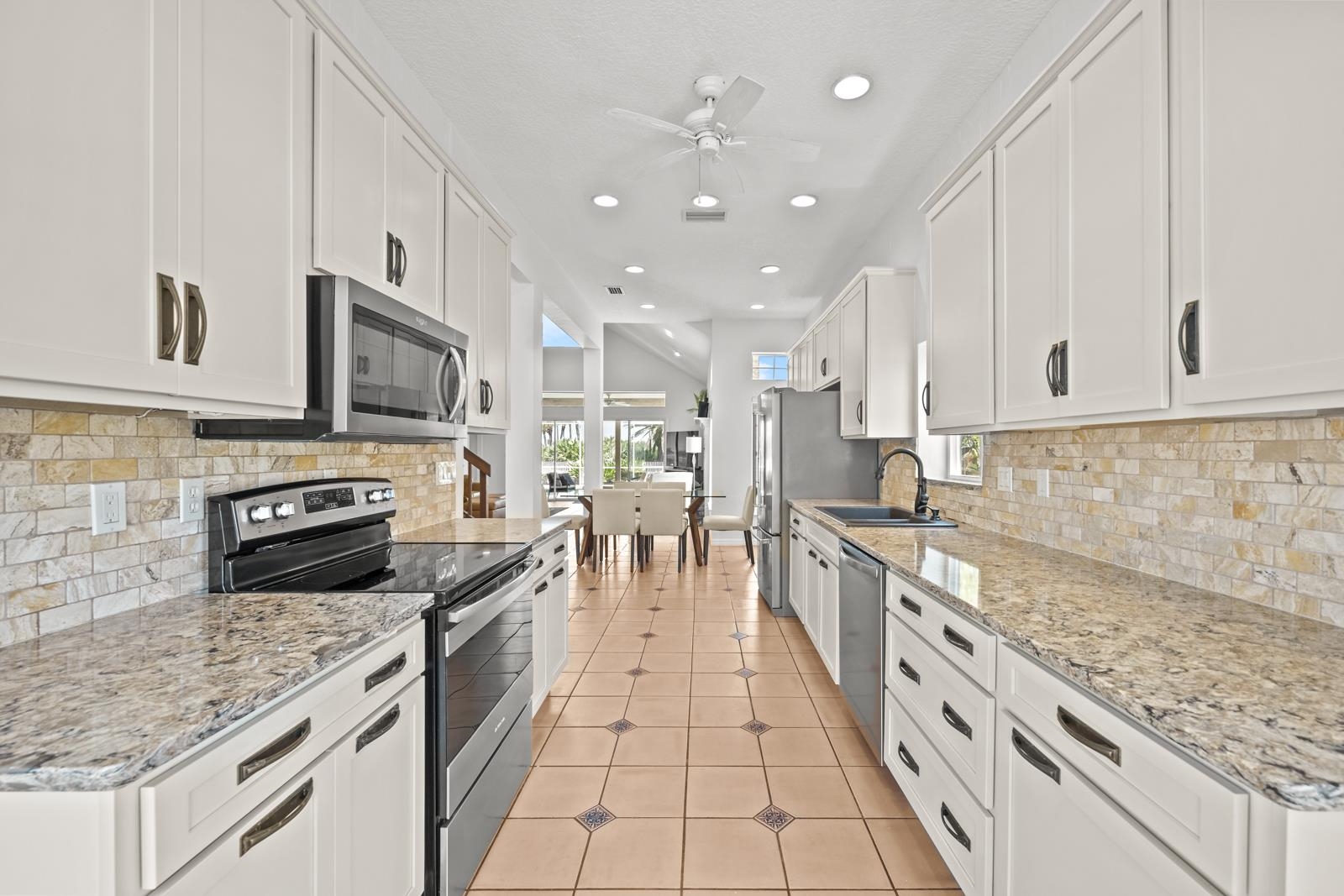 9224 July Lane St. Augustine, FL 32080 - Photo 26 of 88 a large kitchen with stainless steel appliances granite countertop a stove sink and cabinets