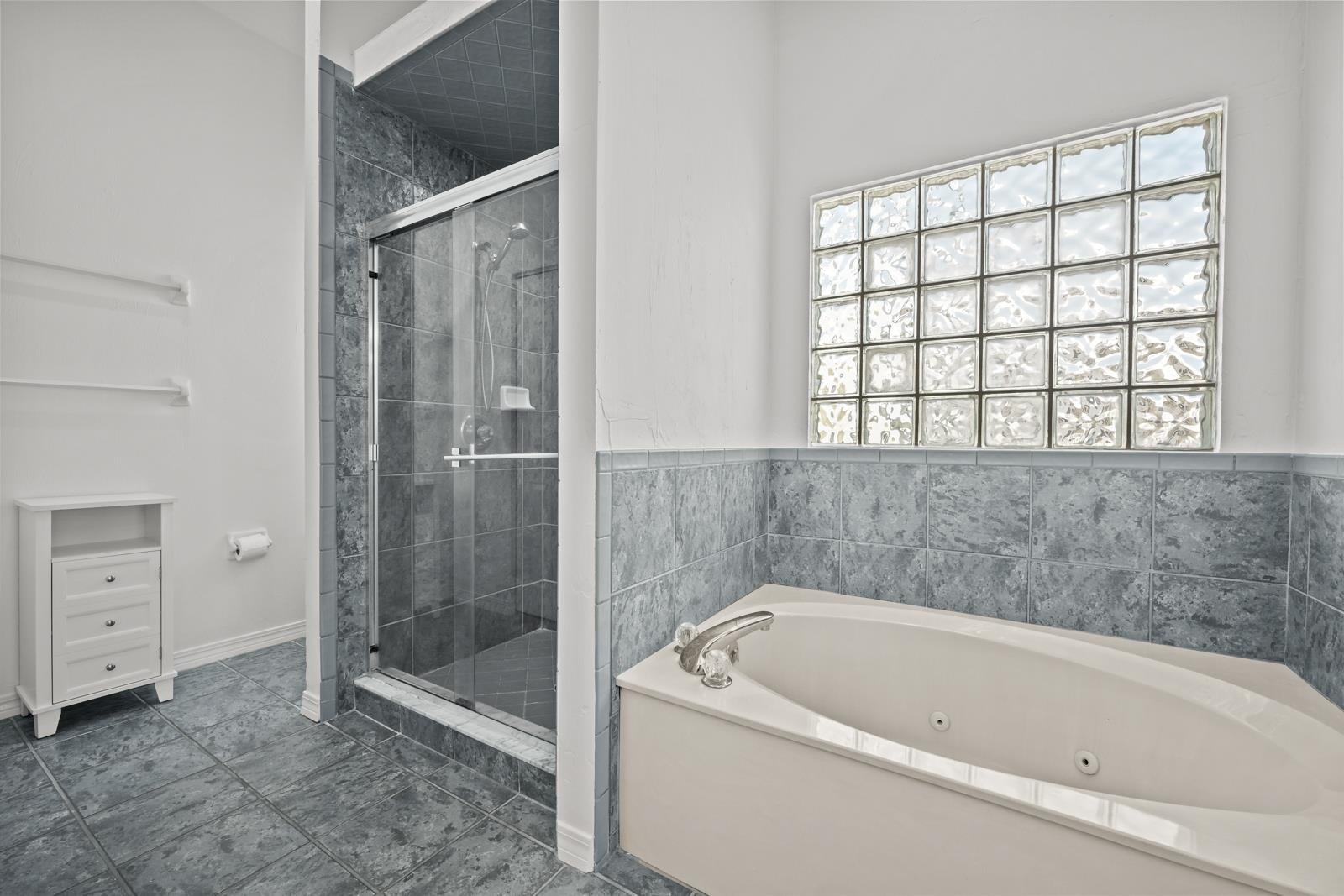 9224 July Lane St. Augustine, FL 32080 - Photo 41 of 88 a bathroom with a bathtub and a shower