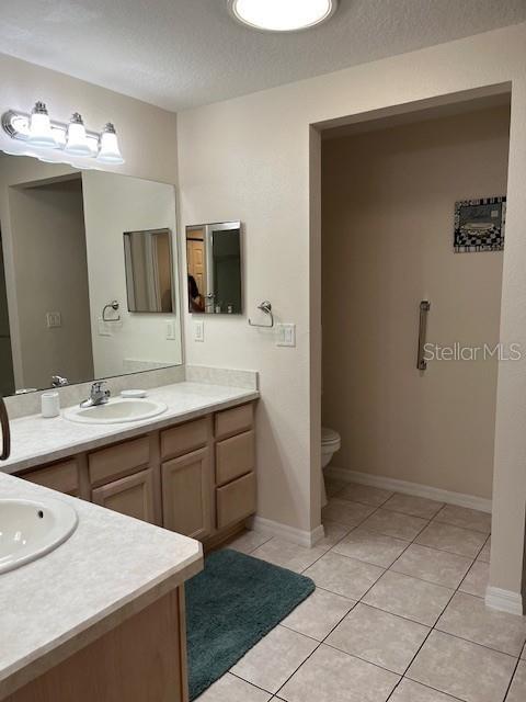 7928 Southwest 80th Pl Road Ocala, FL 34476 - Photo 15 of 30 a spacious bathroom with a mirror sink and toilet