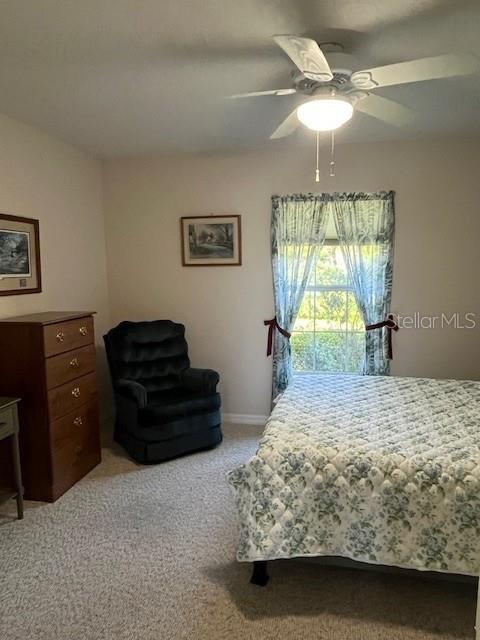 7928 Southwest 80th Pl Road Ocala, FL 34476 - Photo 22 of 30 a bedroom with a bed and a chandelier