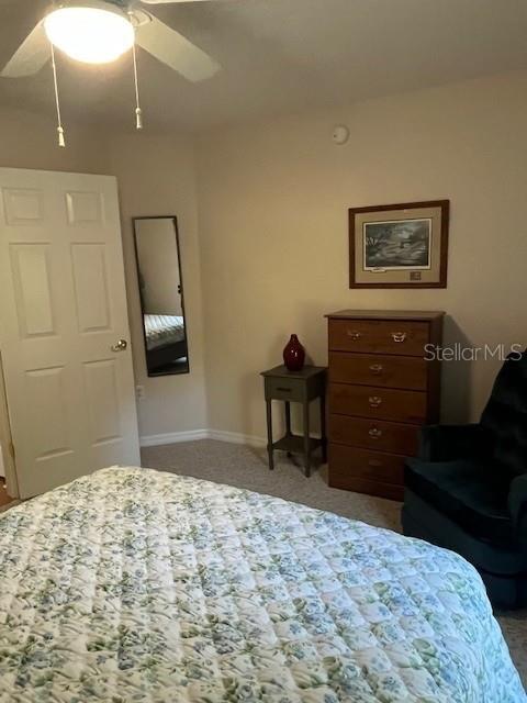 7928 Southwest 80th Pl Road Ocala, FL 34476 - Photo 24 of 30 a bedroom with a bed and a dresser in it
