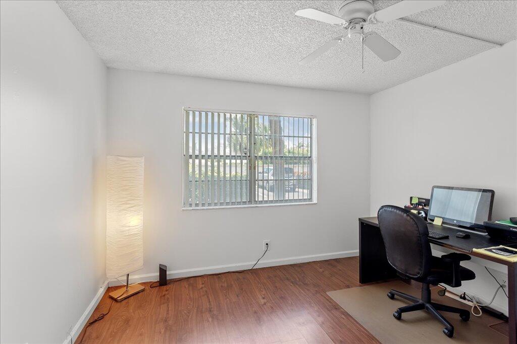 1124 Northwest 13th Street, Unit 120A Boca Raton, FL 33486 - Photo 12 of 23 a workspace with wooden floor and a window