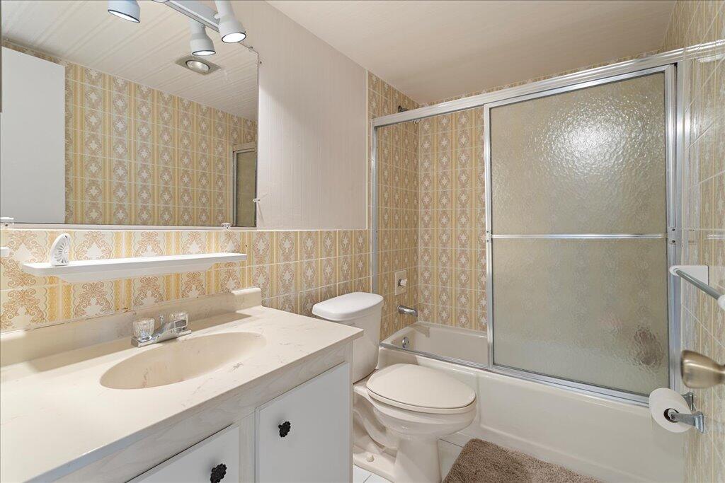 1124 Northwest 13th Street, Unit 120A Boca Raton, FL 33486 - Photo 14 of 23 a bathroom with a sink toilet and shower
