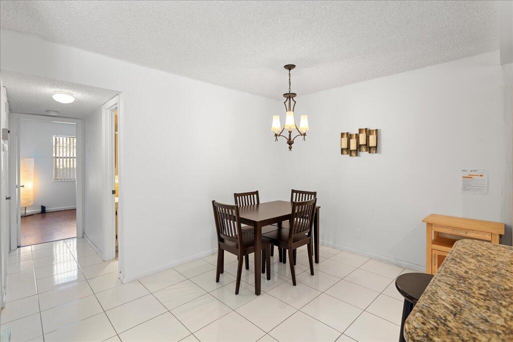 1124 Northwest 13th Street, Unit 120A Boca Raton, FL 33486 - Photo 7 of 23 a view of a dining room with furniture